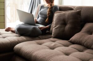 Woman on sofa with laptop